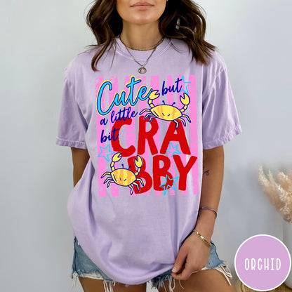 Comfort Colors tee in Orchid featuring graphic design with crabs and text reading Cute but a little bit Crabby