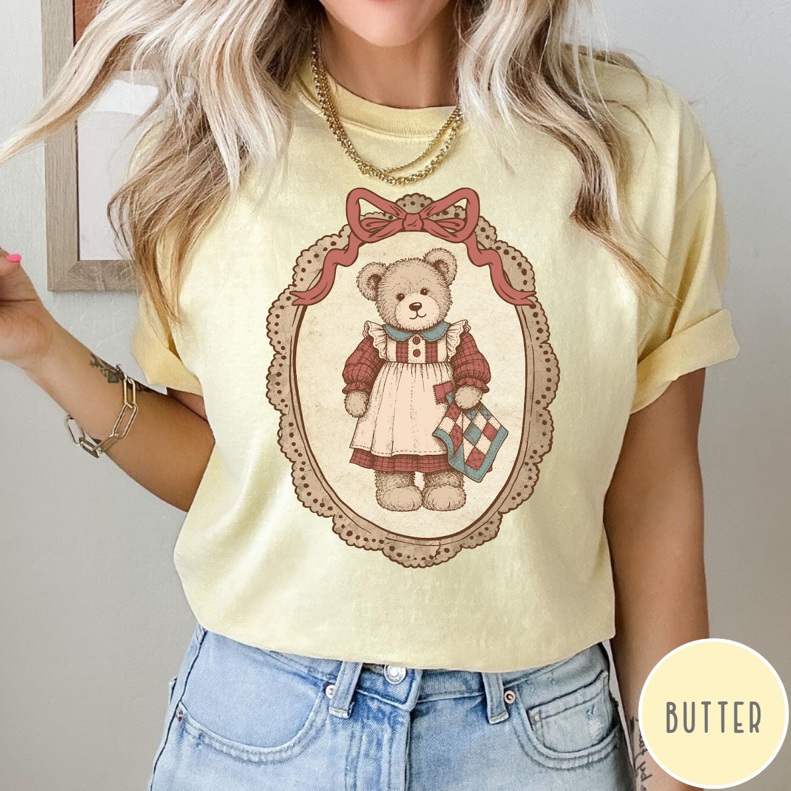 Comfort Colors tee in Butter featuring vintage style teddy bear graphic inside a decorative lace oval frame