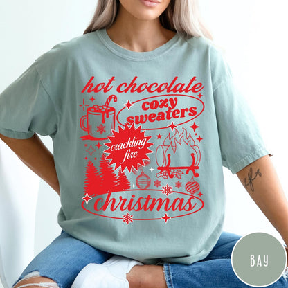 Comfort Colors tee in Bay featuring holiday graphic design with hot chocolate, fire, and Christmas trees