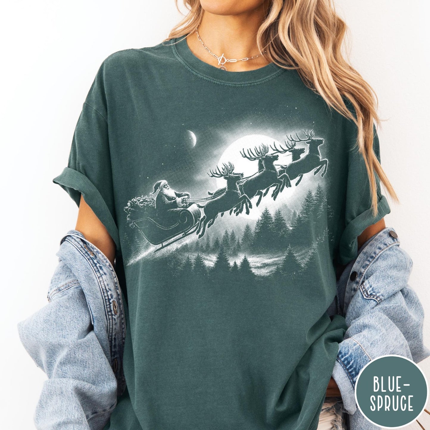 Comfort Colors tee in Blue Spruce featuring vintage style Santa Claus flying in a sleigh with reindeer