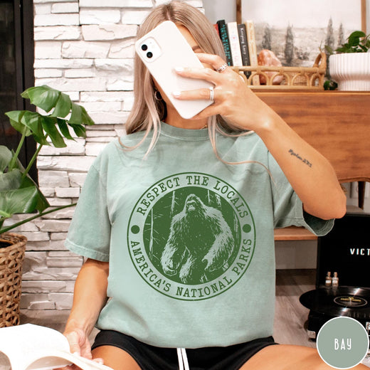 Comfort Colors tee in Bay featuring circular graphic design with Bigfoot and Respect the Locals text