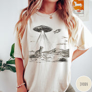 Comfort Colors tee in Ivory featuring retro graphic style cat and UFO abduction scene in black ink