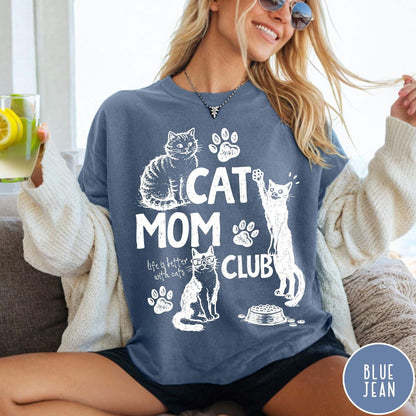 Comfort Colors tee in Blue Jean featuring vintage style graphic with cats, paw prints, and cat mom club text