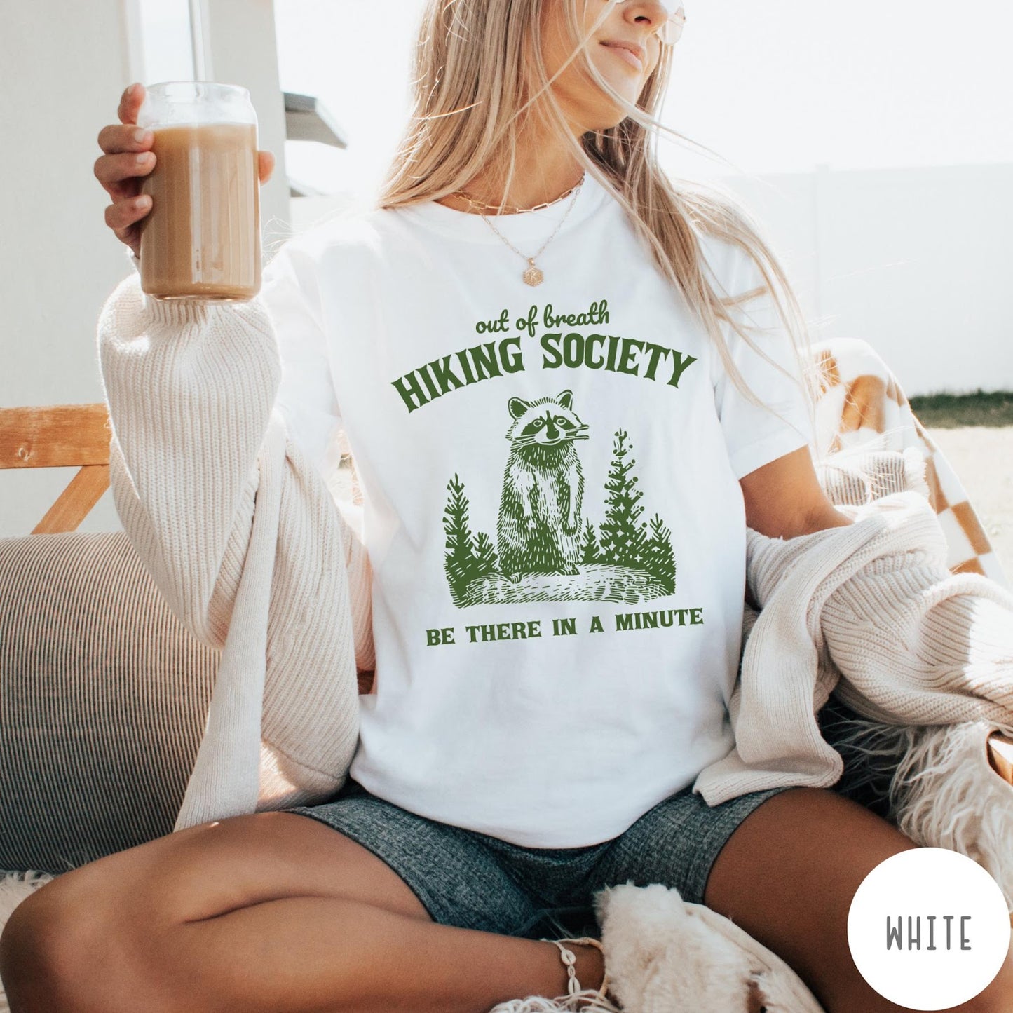 Comfort Colors tee in White featuring outdoor style graphic of a raccoon standing in the forest