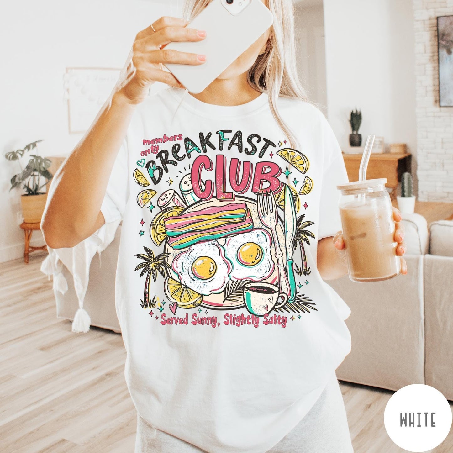 Comfort Colors tee in White featuring breakfast food graphic with bacon, eggs, coffee, and palm trees.