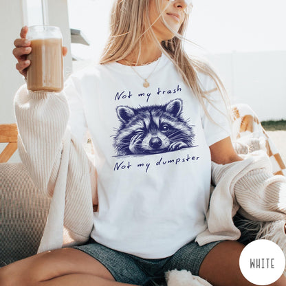 Comfort Colors tee in White featuring illustrated style graphic of a winking raccoon with text not my trash