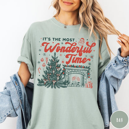Comfort Colors tee in Bay featuring Christmas design with a decorated tree and a cozy fireplace scene