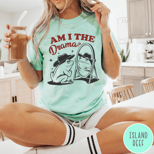 Comfort Colors tee in Island Reef featuring whimsical frog graphic with a cowboy hat looking into a mirror