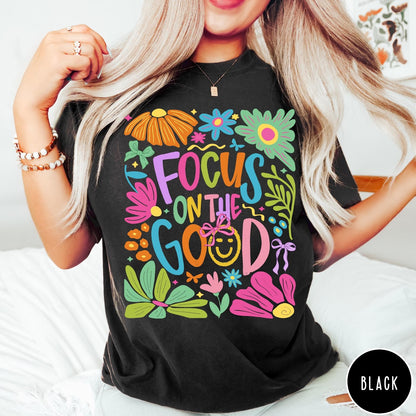 Comfort Colors tee in Black featuring colorful typography and floral collage with a smiley face graphic design