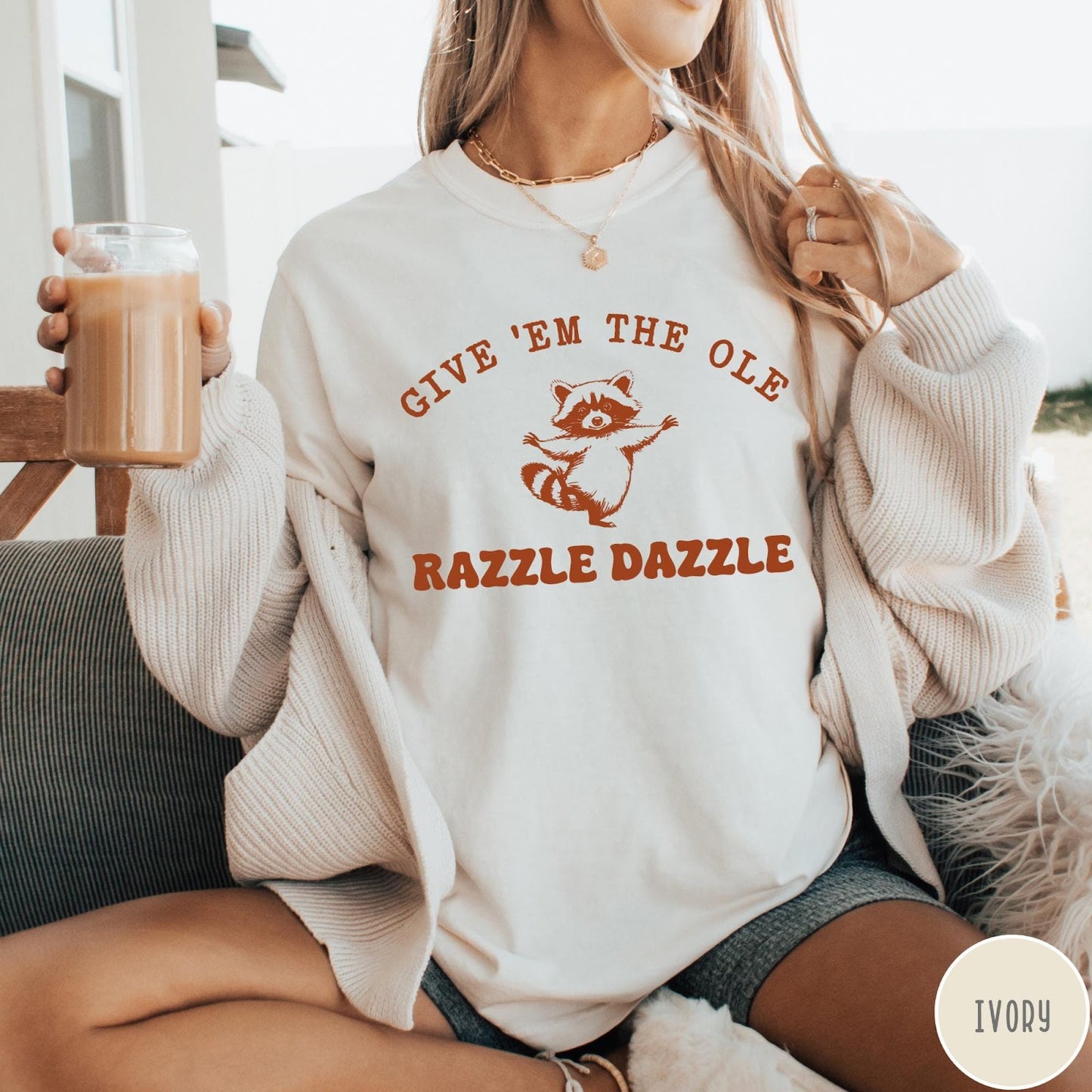 Comfort Colors tee in Ivory featuring whimsical raccoon graphic with Give Em The Ole Razzle Dazzle text