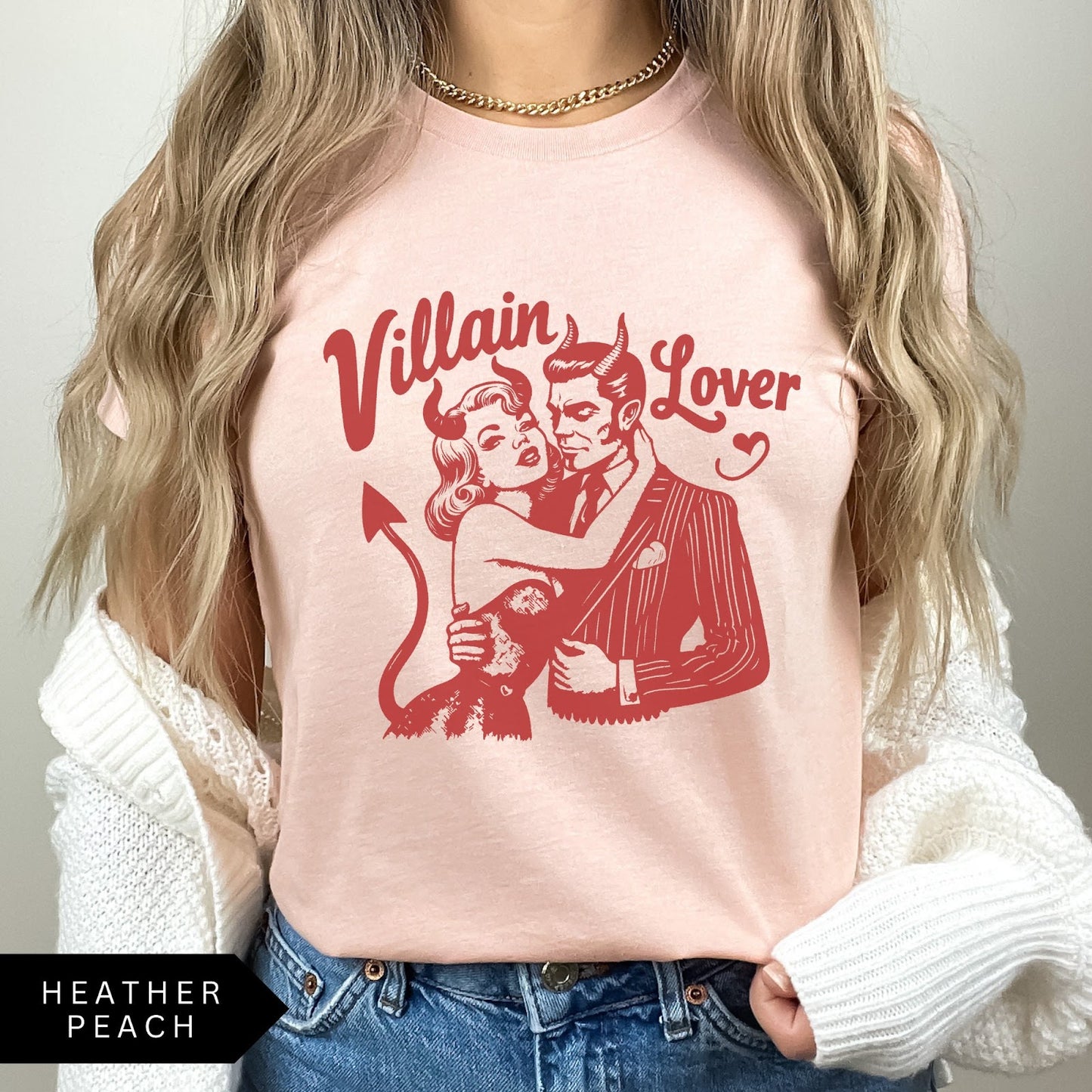 Comfort Colors tee in Heather Peach featuring vintage style graphic of a devilish couple embracing with text Villain Lover