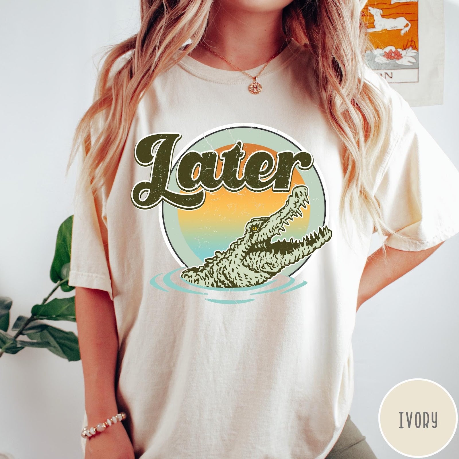 Comfort Colors tee in Ivory featuring vintage style graphic of an alligator emerging from water with sunset background