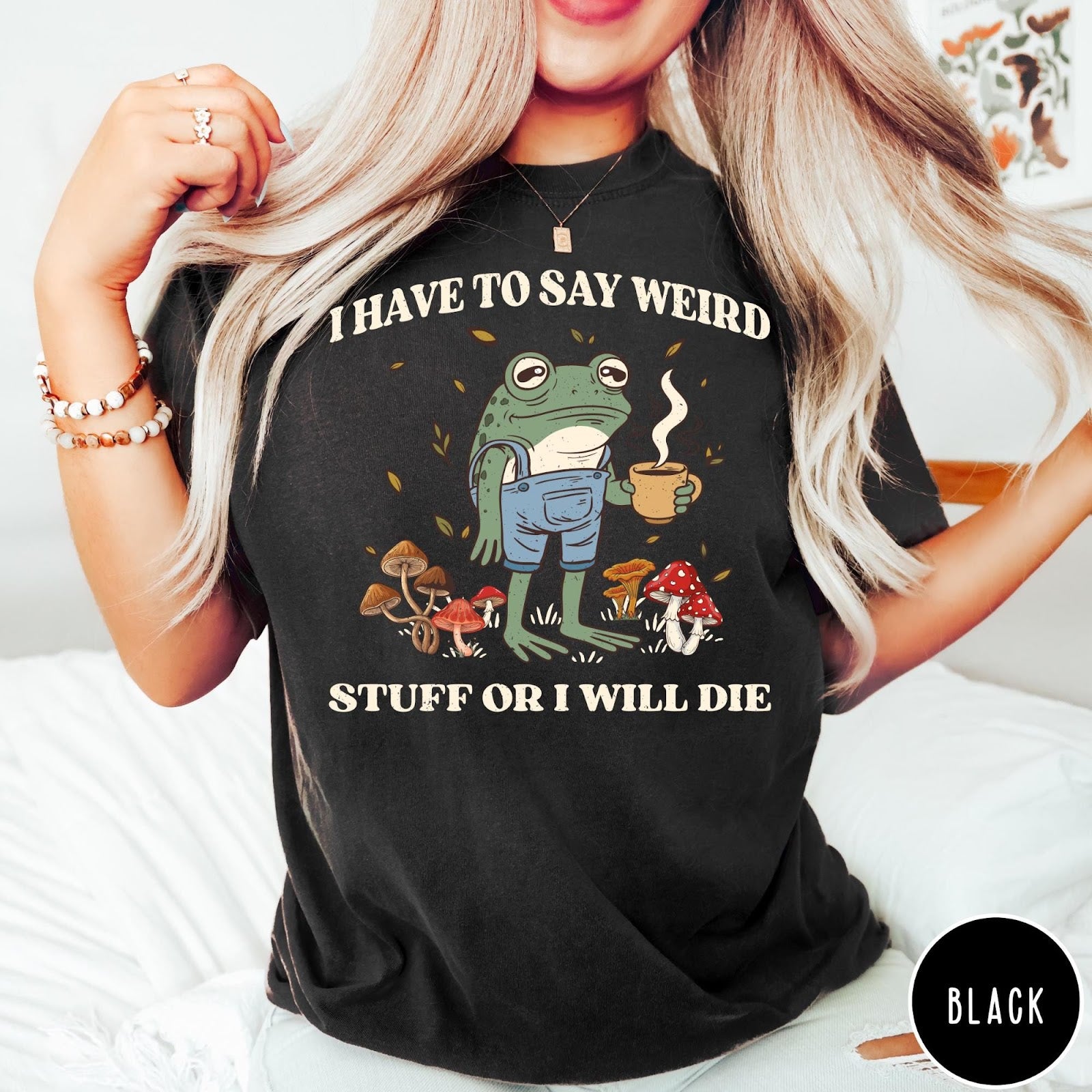 Comfort Colors tee in Black featuring cartoon style frog wearing overalls holding a coffee mug with mushrooms