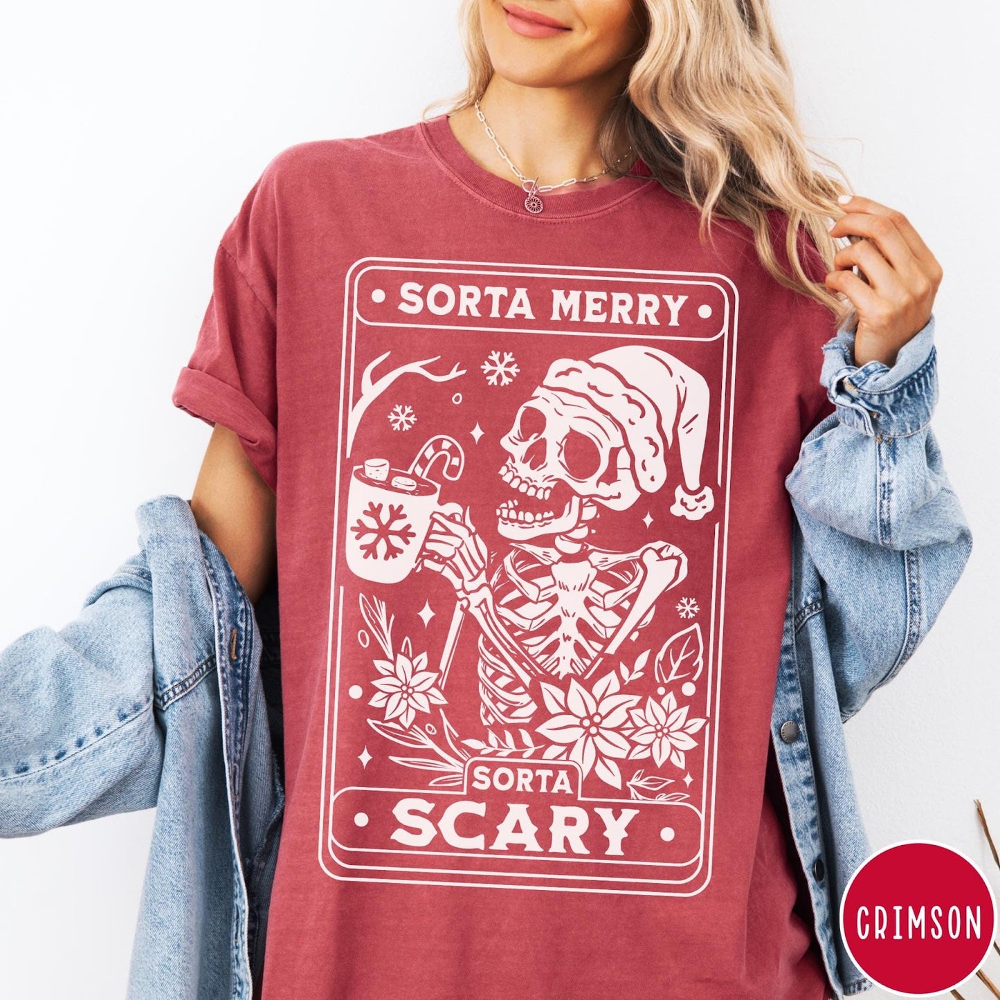 Comfort Colors tee in Crimson featuring graphic design of a skeleton in a Santa hat holding cocoa