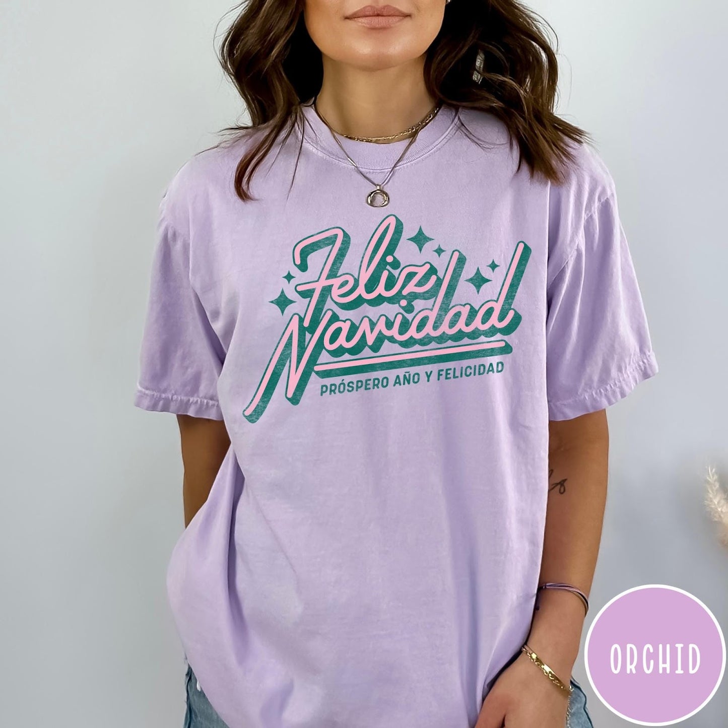 Comfort Colors tee in Orchid featuring retro Christmas style Feliz Navidad greeting with stars and holiday text