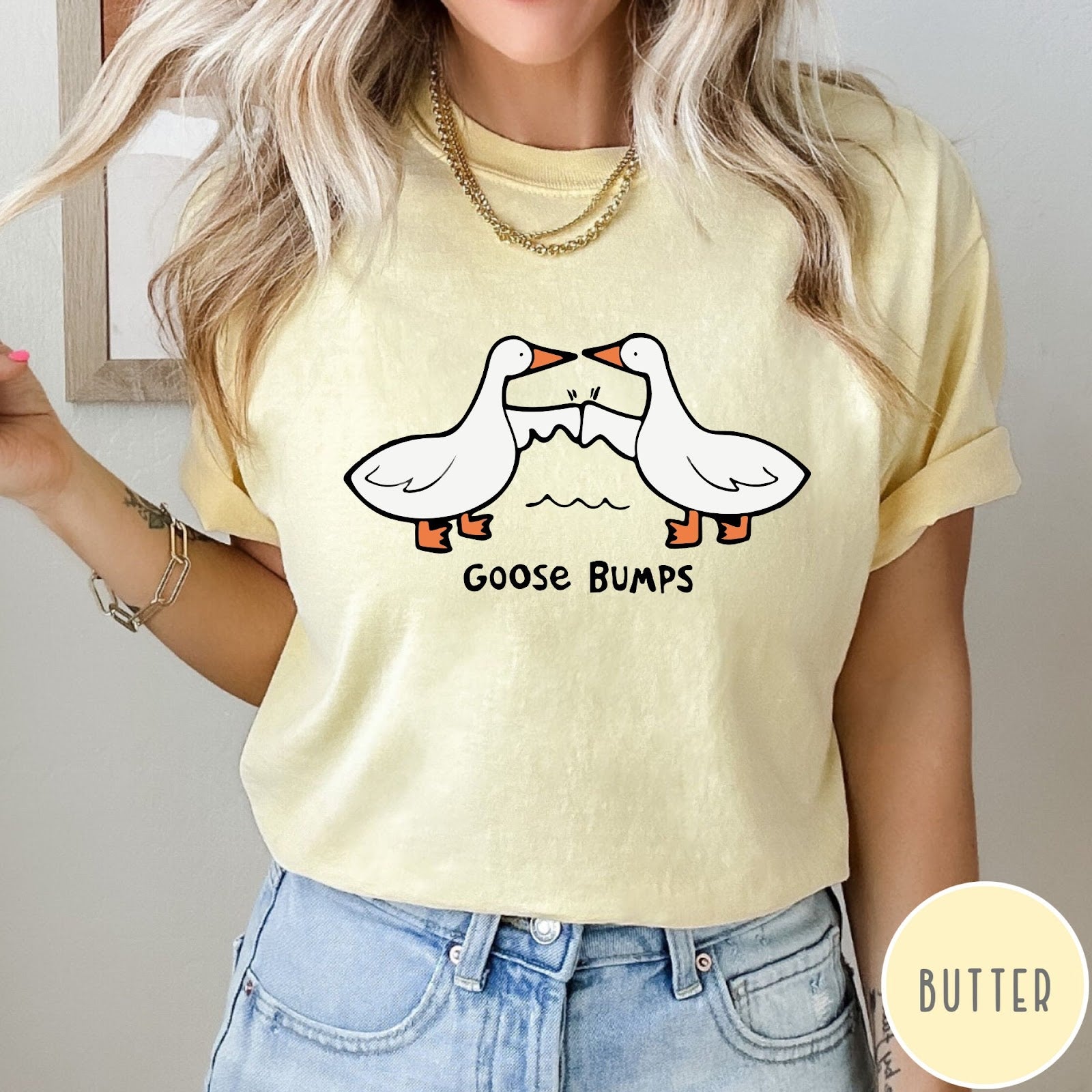 Comfort Colors tee in Butter featuring cartoon style graphic of two geese giving each other a fist bump