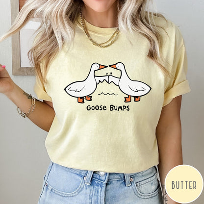 Comfort Colors tee in Butter featuring cartoon style graphic of two geese giving each other a fist bump