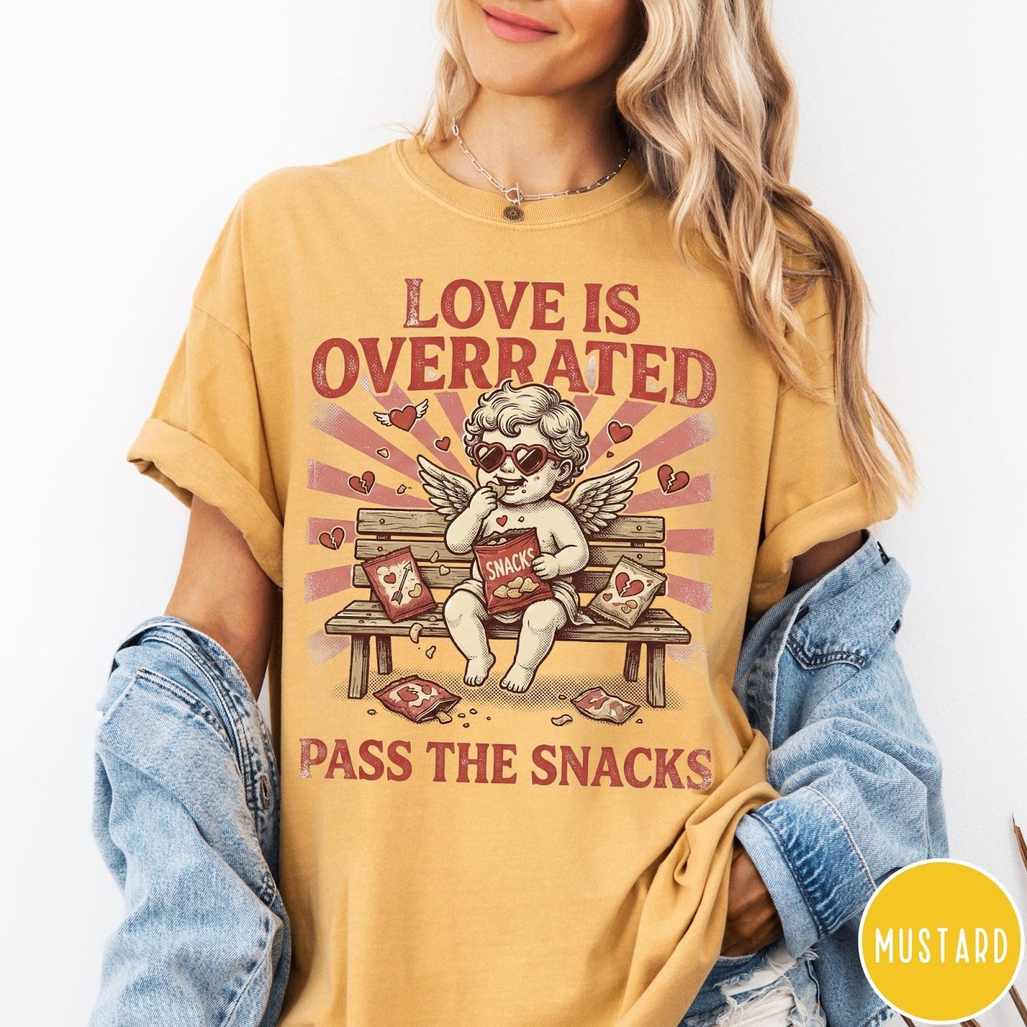 Comfort Colors tee in Mustard featuring vintage style graphic of a cherub eating snacks on a bench