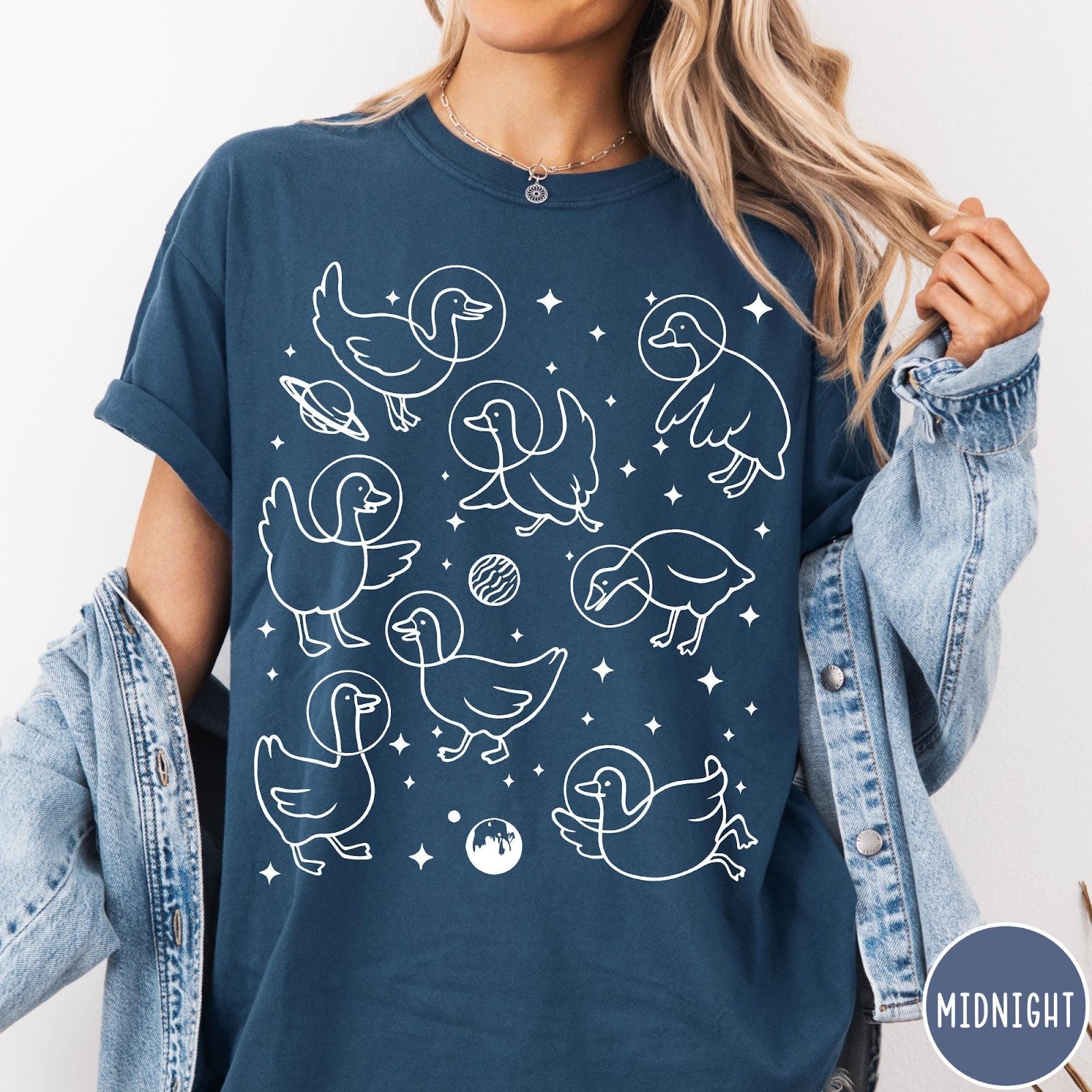 Comfort Colors tee in Midnight featuring line art graphic of multiple geese wearing astronaut helmets in space