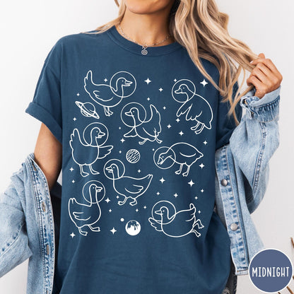 Comfort Colors tee in Midnight featuring line art graphic of multiple geese wearing astronaut helmets in space