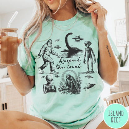 Comfort Colors tee in Island Reef featuring vintage style cryptid graphic with Bigfoot, UFOs, and alien creatures.