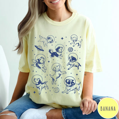 Comfort Colors tee in Banana featuring space theme graphic with various dogs wearing astronaut helmets and planets