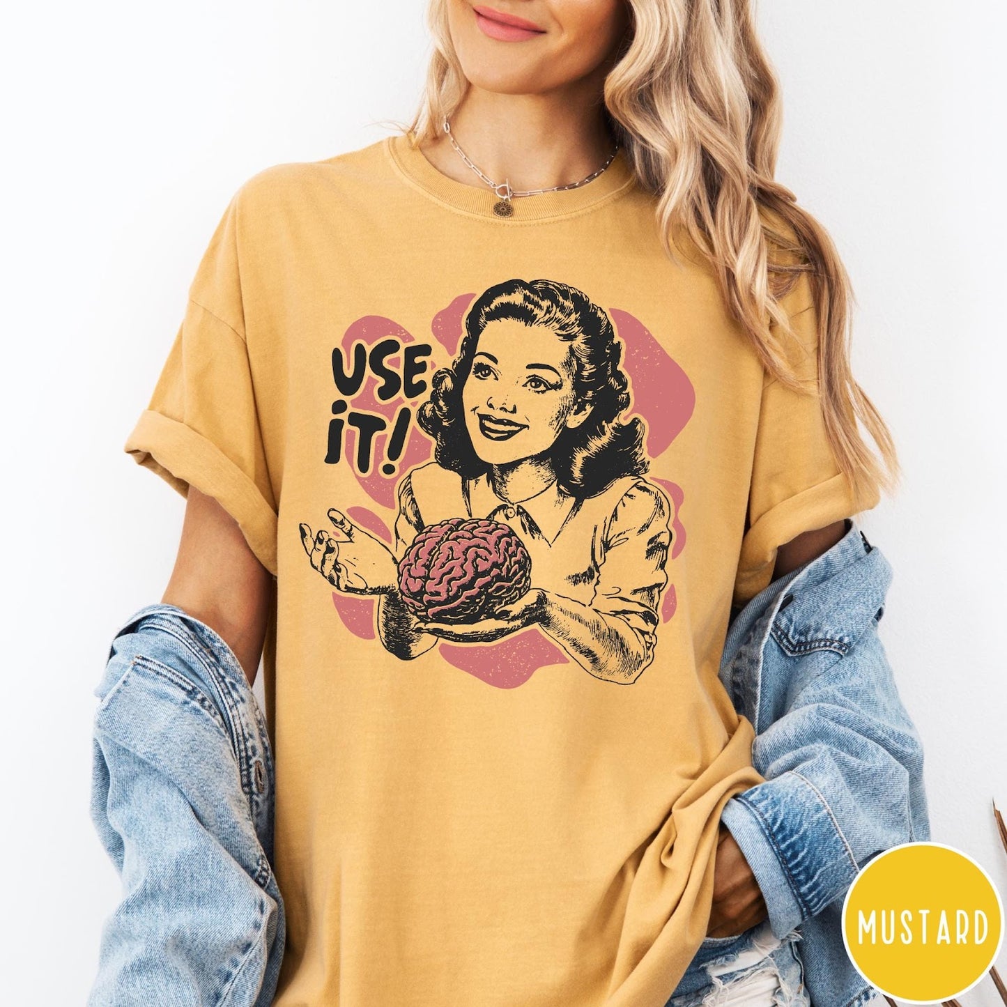 Comfort Colors tee in Mustard featuring retro design of a woman holding a brain with text Use It