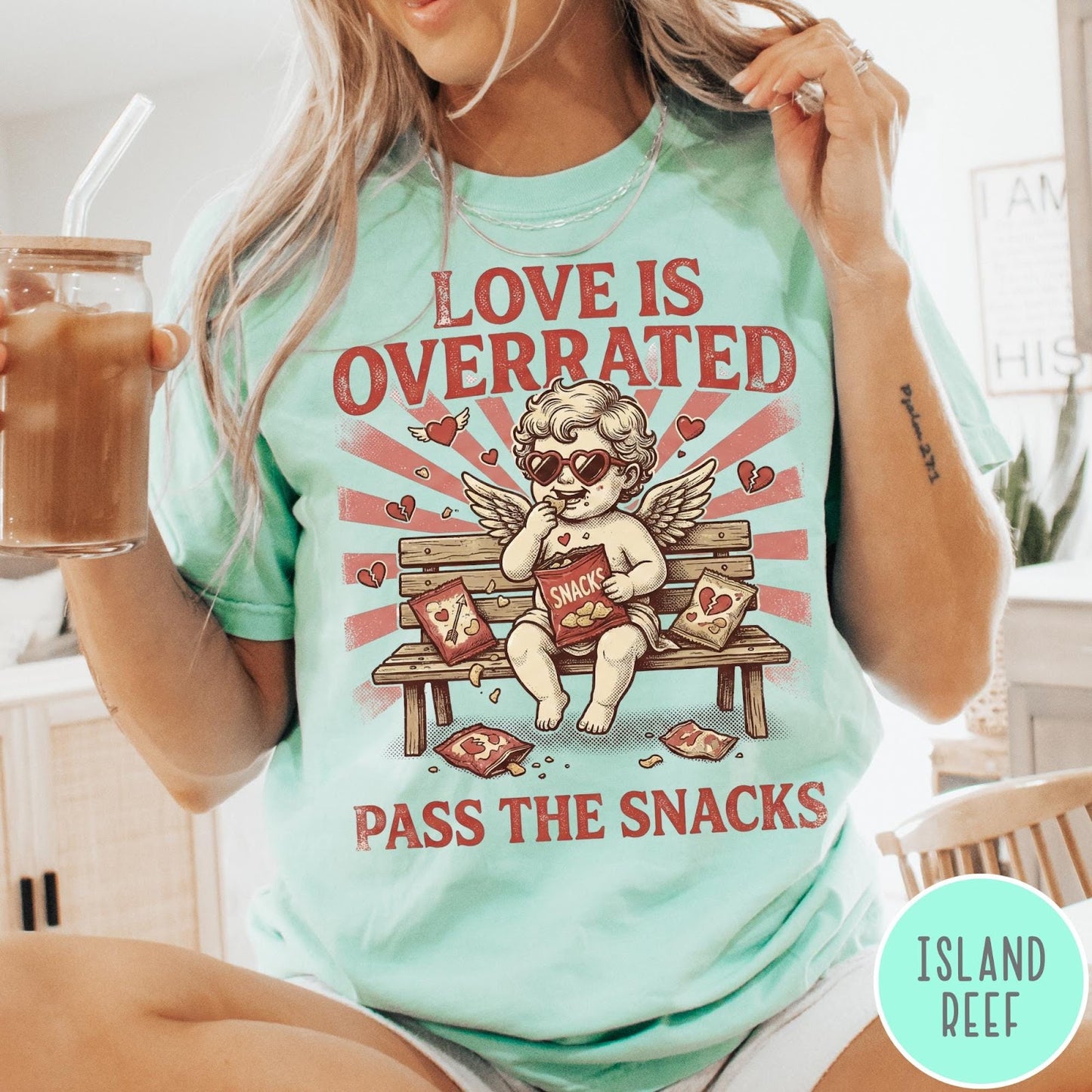 Comfort Colors tee in Island Reef featuring vintage style graphic of a cherub eating snacks on a bench