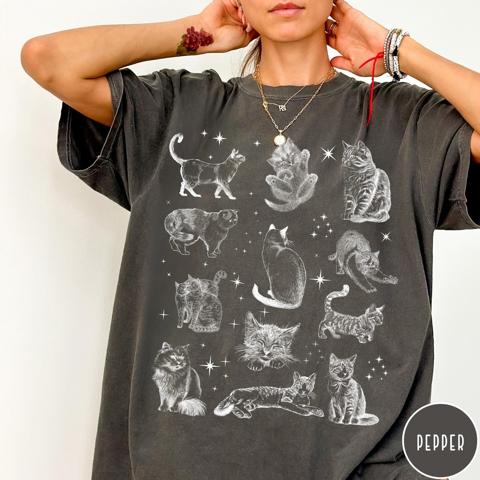 Comfort Colors tee in Pepper featuring vintage style graphic illustration of various cats and celestial stars