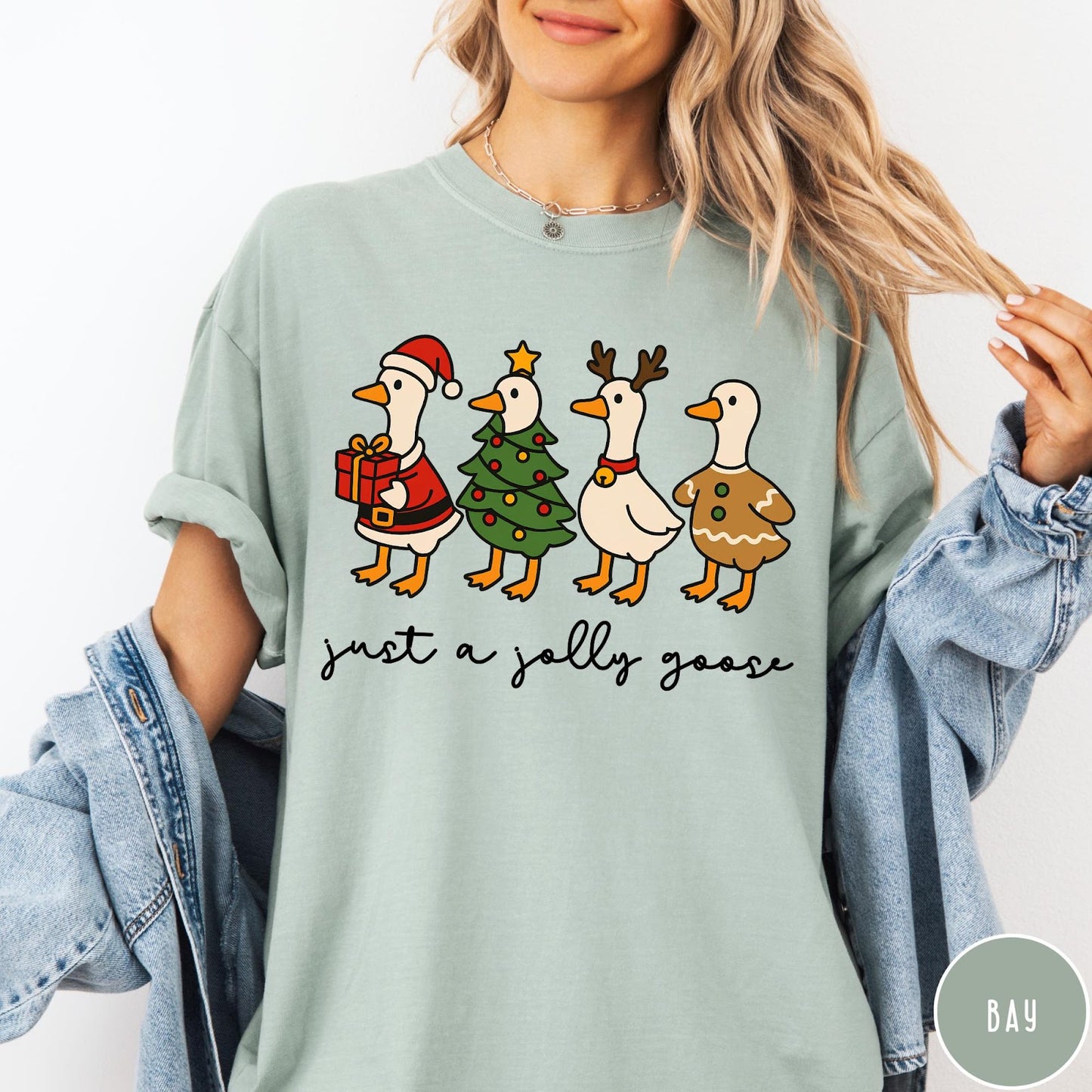 Comfort Colors tee in Bay featuring festive geese dressed as Santa, Christmas tree, reindeer, and gingerbread