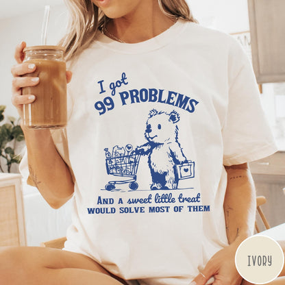 Comfort Colors tee in Ivory featuring graphic design of a bear pushing a shopping cart with treats