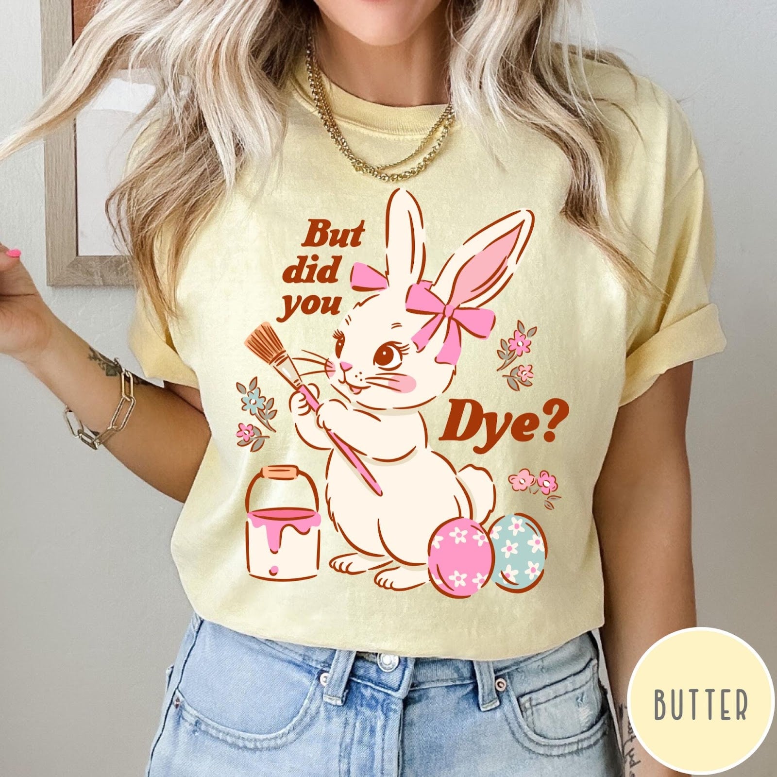 Comfort Colors tee in Butter featuring Easter bunny design with paintbrush, paint bucket, and decorated Easter eggs