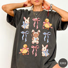 Comfort Colors tee in Pepper featuring vintage graphic style with Easter bunnies, ducks, and pink blue bows