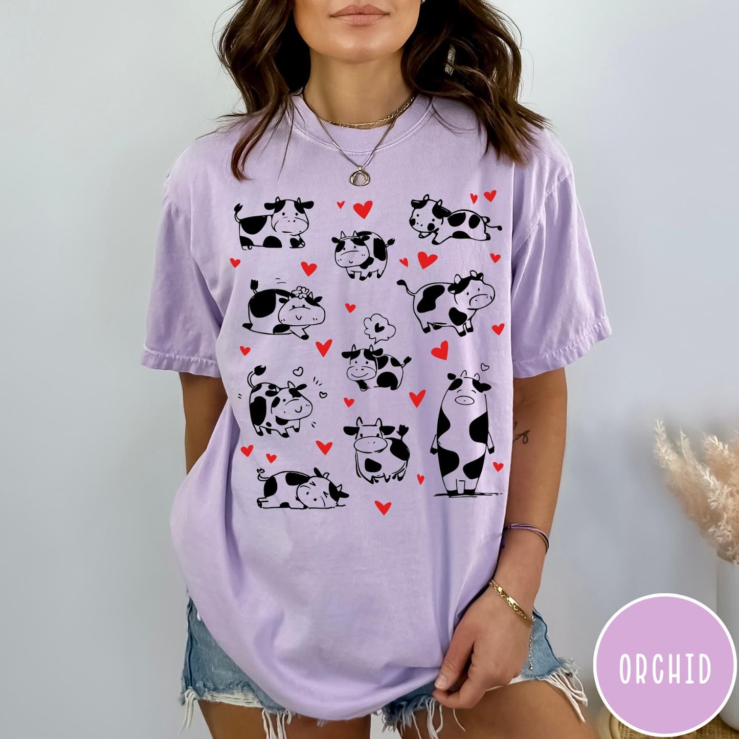 Comfort Colors tee in Orchid featuring cute cow lover graphic with various black and white cow illustrations