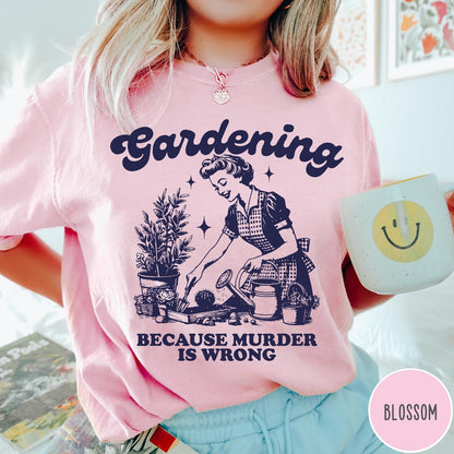Comfort Colors tee in Blossom featuring vintage style graphic of a woman gardening with text about murder.