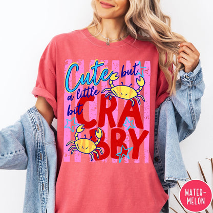 Comfort Colors tee in Watermelon featuring playful graphic text and yellow crab illustrations with pink stripes