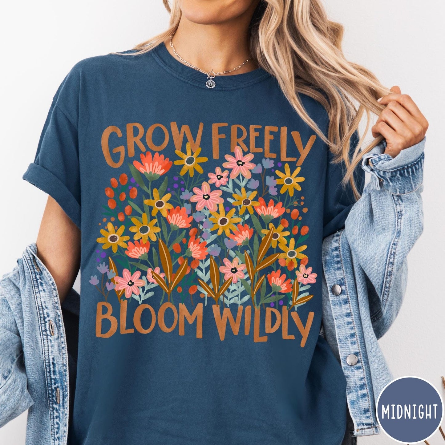 Comfort Colors tee in Midnight featuring wildflower design with text Grow Freely Bloom Wildly in earthy tones