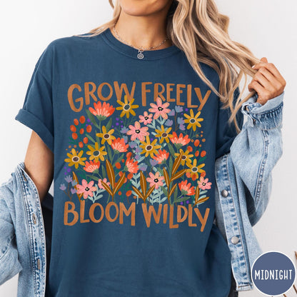 Comfort Colors tee in Midnight featuring wildflower design with text Grow Freely Bloom Wildly in earthy tones