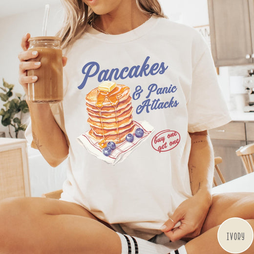 Comfort Colors tee in Ivory featuring watercolor style graphic of a stack of pancakes with blueberries and syrup