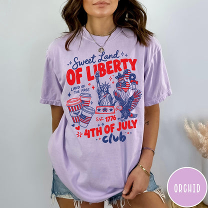 Comfort Colors tee in Orchid featuring patriotic 4th of July graphic with Statue of Liberty and eagle