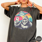 Comfort Colors tee in Pepper featuring retro graphic design of Bigfoot taking a selfie with a UFO