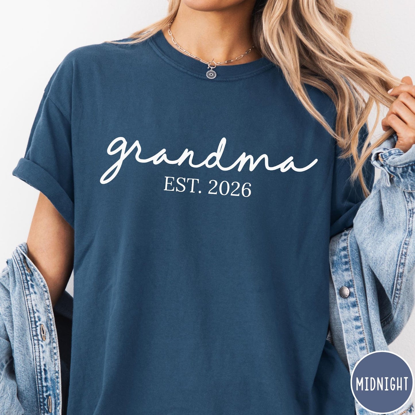 Comfort Colors tee in Midnight featuring script design Grandma Est. 2026 announcement graphic in white