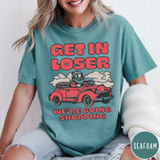 Comfort Colors tee in Seafoam featuring retro style graphic of Santa Claus driving a red convertible car