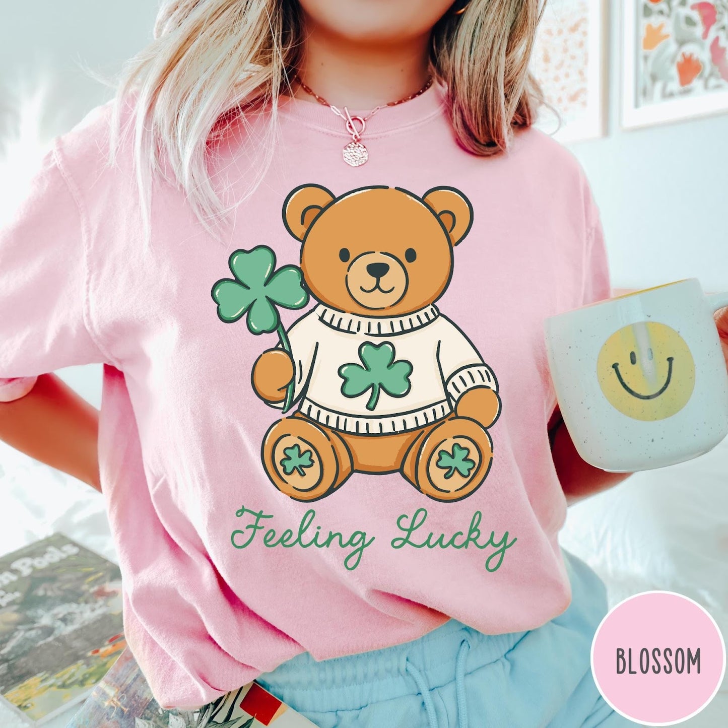 Comfort Colors tee in Blossom featuring cute teddy bear graphic wearing a sweater with shamrocks
