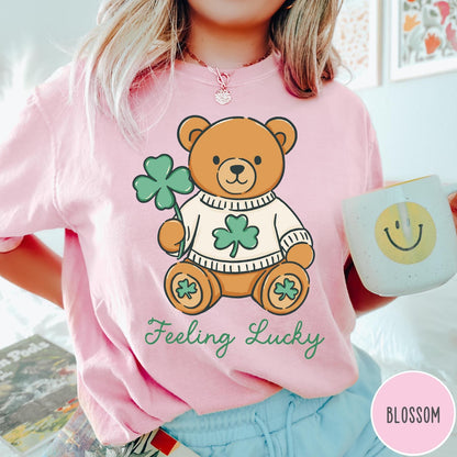 Comfort Colors tee in Blossom featuring cute teddy bear graphic wearing a sweater with shamrocks