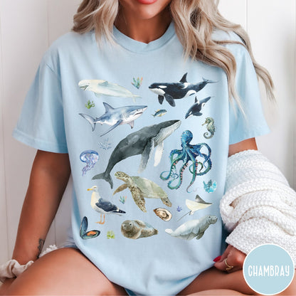 Comfort Colors tee in Chambray featuring watercolor style graphic of various ocean animals including whales and sharks