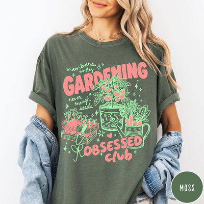Comfort Colors tee in Moss featuring retro graphic gardening design with tomato plant, seeds, and gardening tools