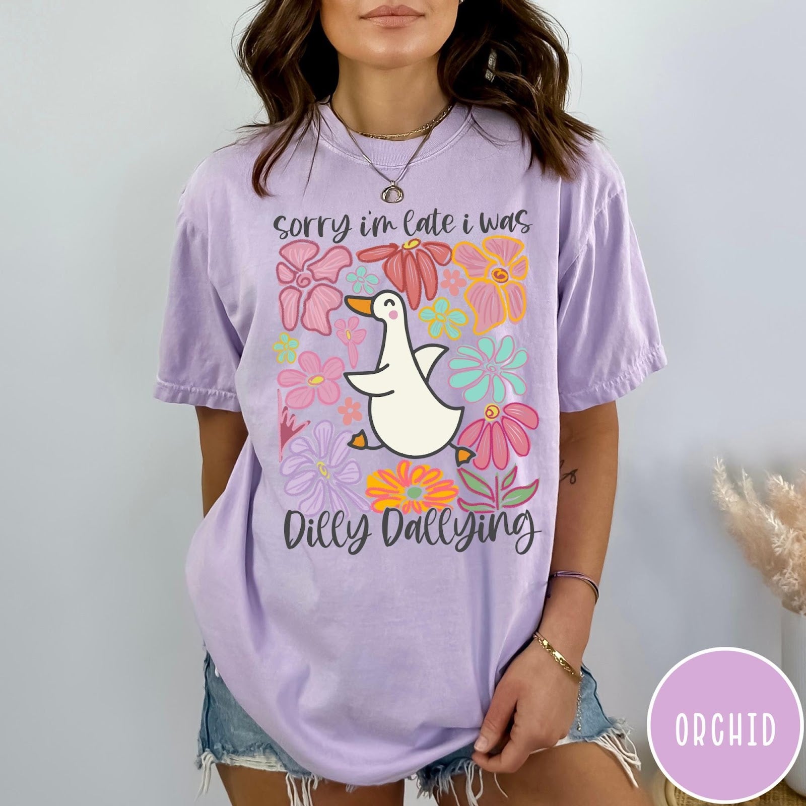 Comfort Colors tee in Orchid featuring cute duck graphic with colorful flowers and Sorry I Was Dilly Dallying text