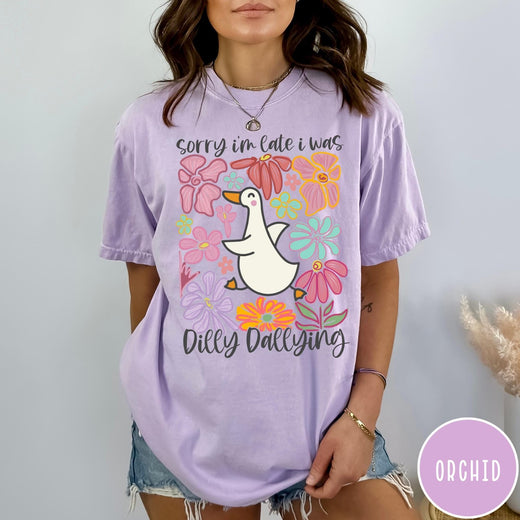 Comfort Colors tee in Orchid featuring cute duck graphic with colorful flowers and Sorry I Was Dilly Dallying text