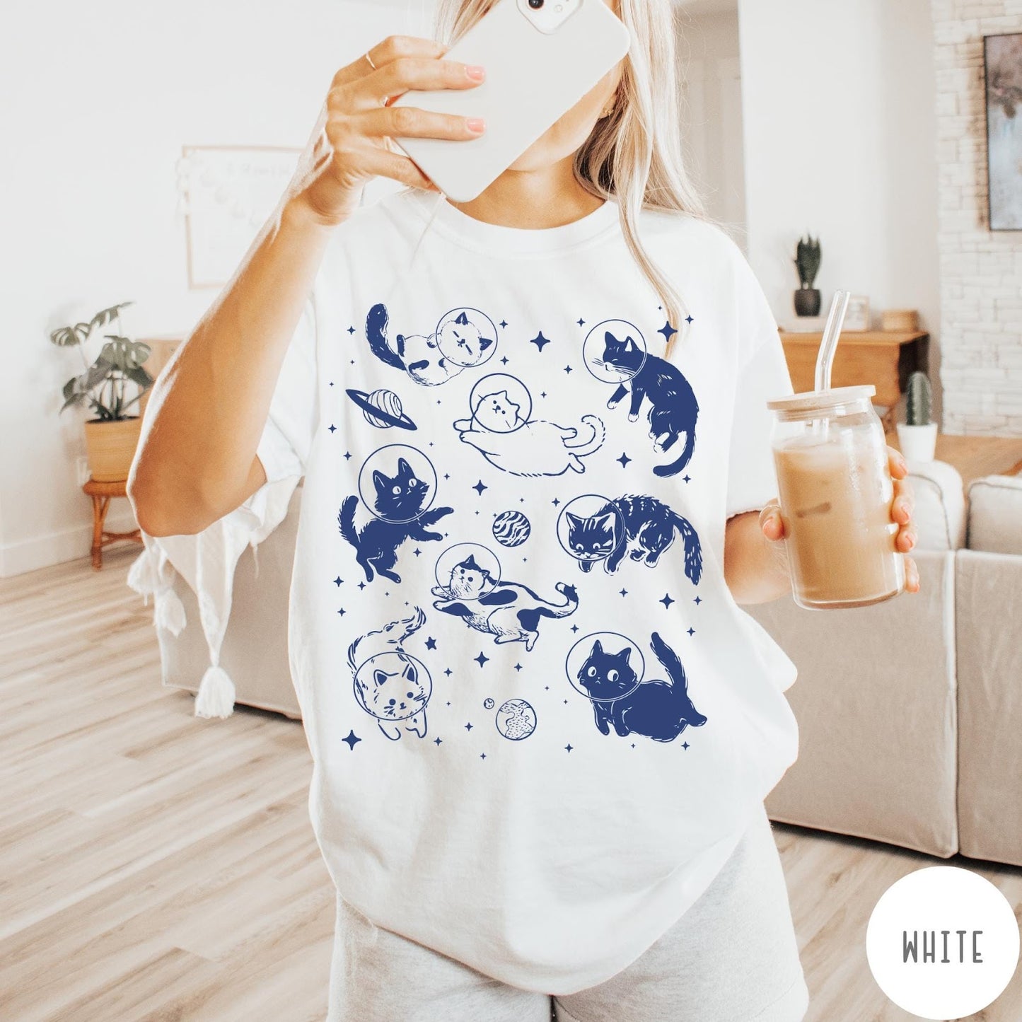 Comfort Colors tee in White featuring whimsical space style graphic with multiple cats floating in space helmets